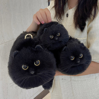 3 Black cat kitten bag purses held in woman's hand